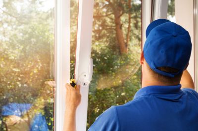 Professional inspecting exterior windows